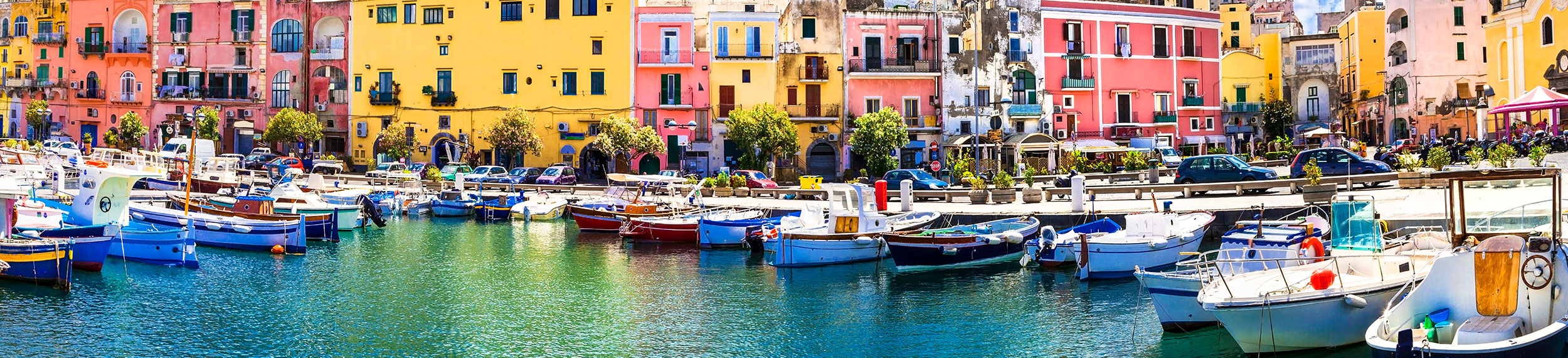 Boat dock area near colorful houses in Terra Murata, Italy. 