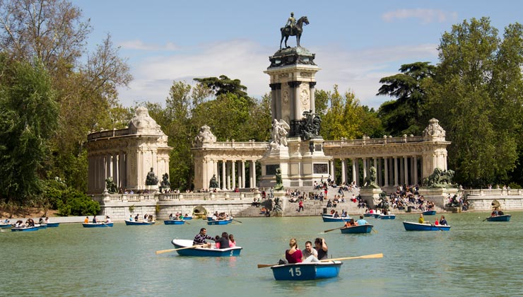 View of the lake and statue in El Retiro Park in Madrid, Spain.