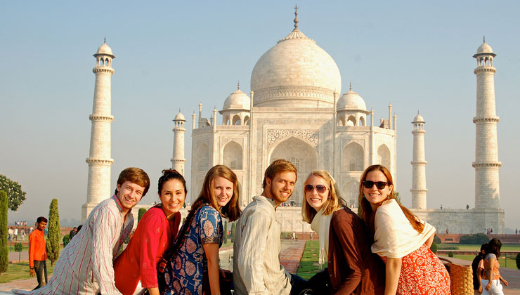 UCEAP students smile for the camera with the Taj Mahal in Agra, India, in the distance.