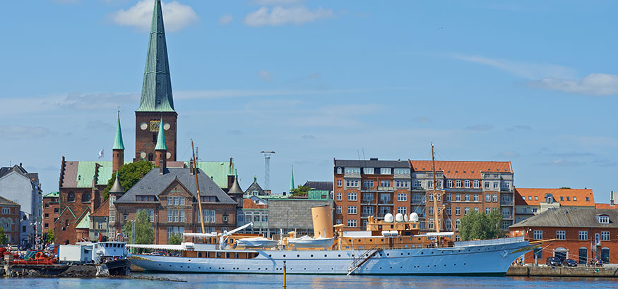 Her Royal Majesty's Yacht Dannebrog docked in the harbor on a beautiful day in Aarhus, Denmark.