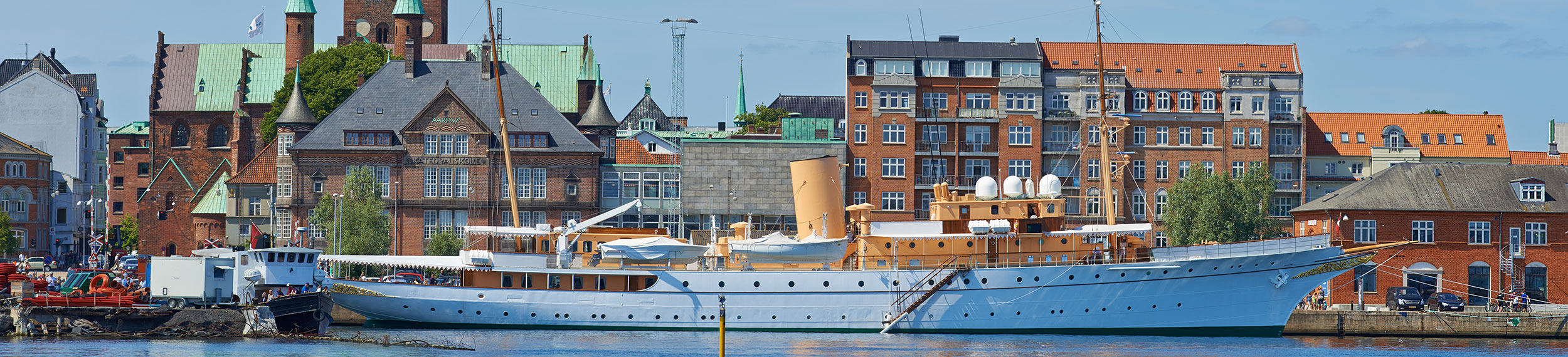 Her Royal Majesty's Yacht Dannebrog docked in the harbor on a beautiful day in Aarhus, Denmark.