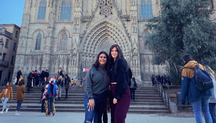 Two students pose in front of a historic chapel in Barcelona, Spain.