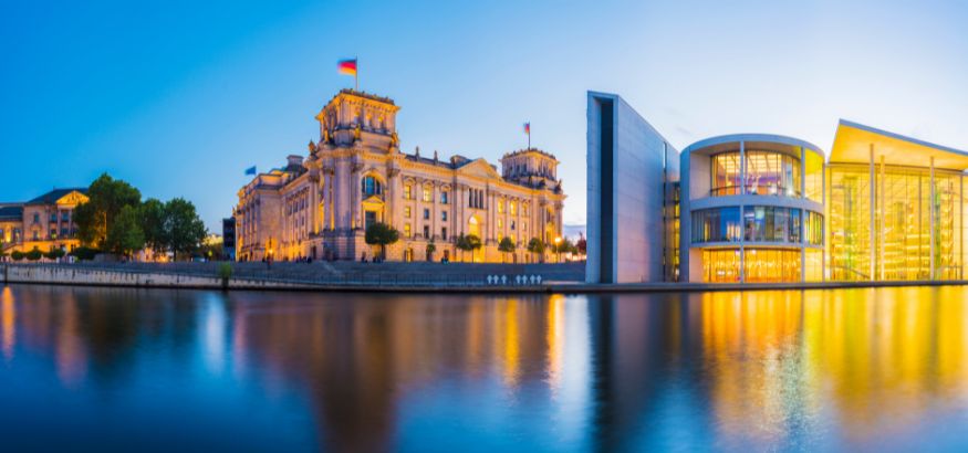A panoramic view of the German Parliament Building and the River Spree at sunset in Berlin, Germany.