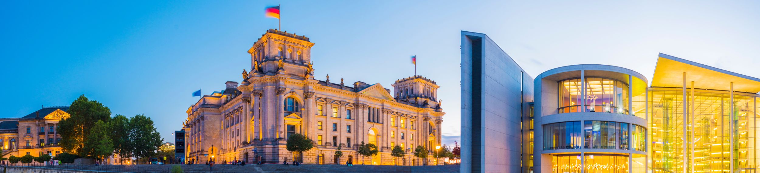 A panoramic view of the German Parliament Building and the River Spree at sunset in Berlin, Germany.