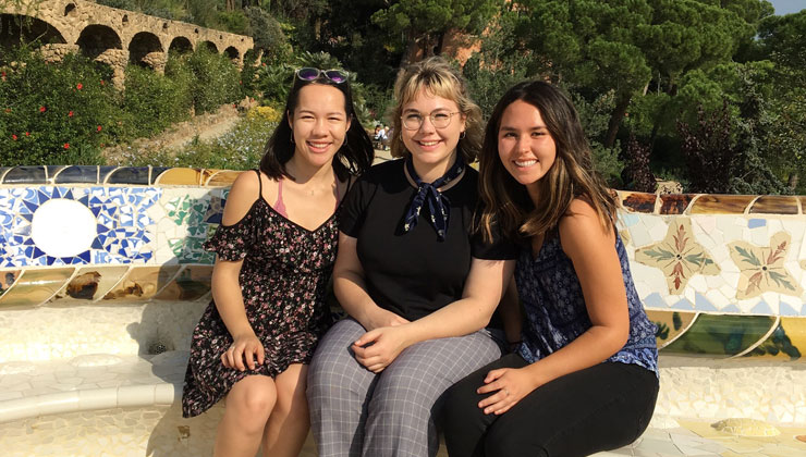 Three students smiling at Park Güell in Barcelona, Spain. 