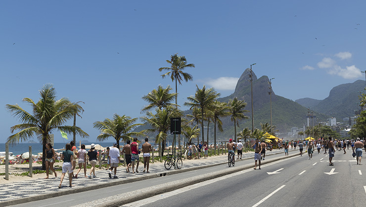 Pedestrians walking along the promenade near Copacabana Beach in Rio de Janeiro, Brazil. 