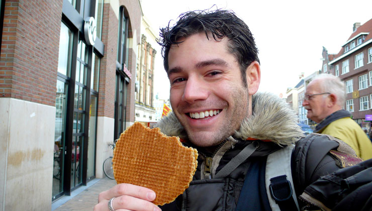 A student eating a Stroopwafel in The Netherlands.