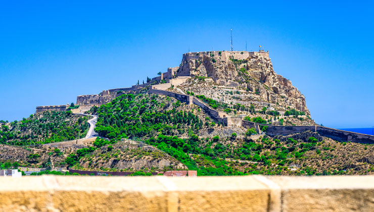 View of the Castle of Santa Bárbara built on a rocky outcrop by the Mediterranean Sea