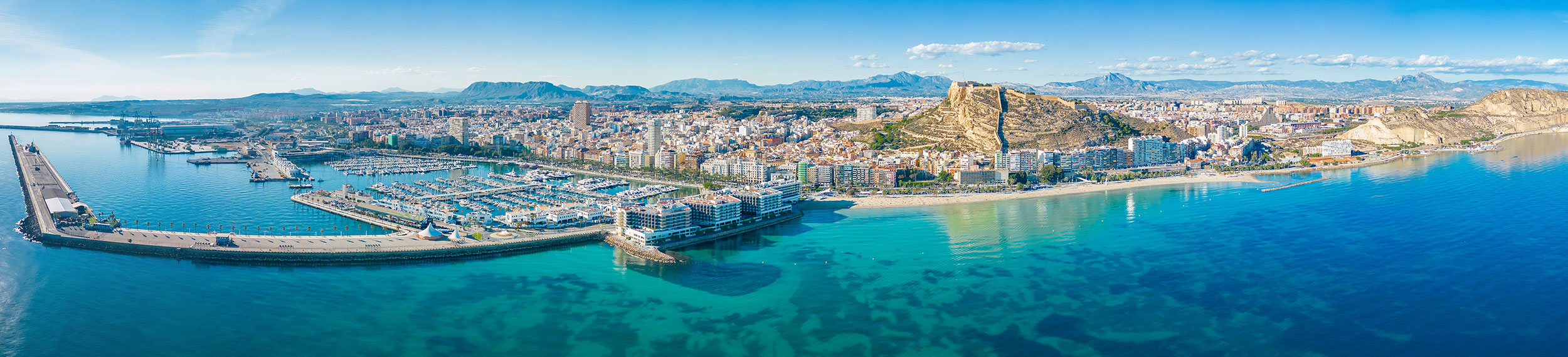 Aerial panoramic view of Alicante, with the Postiguet Beach, port of Alicante, and the Castle of Santa Barbara
