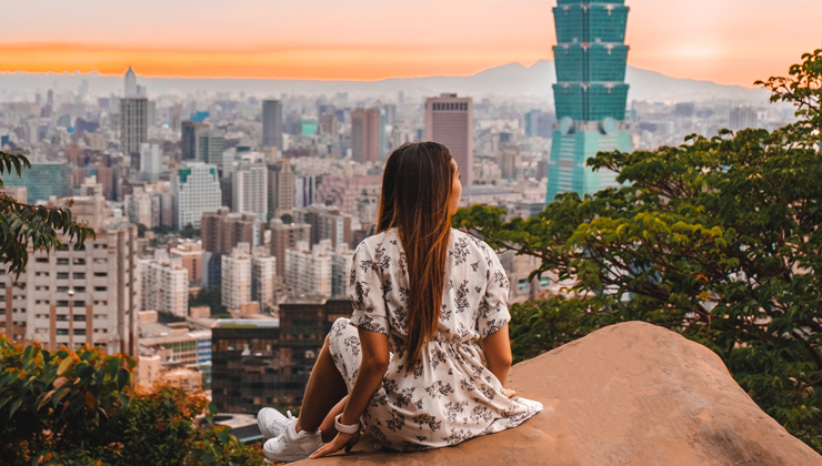 Individual admiring the view of Taipei from Elephant Mountain. 