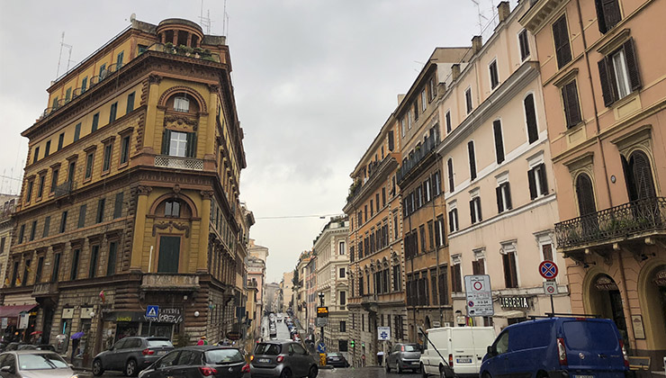 A busy street in Rome on an overcast day.