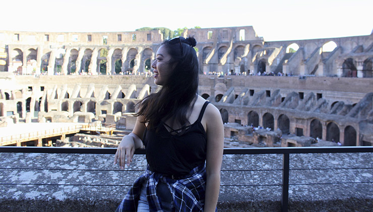 A student looks out over the Roman Colosseum in Rome, Italy.