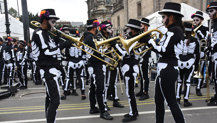 Musicians dressed in skeleton costume participate in a parade for Day of the Dead in Zocalo Square in Mexico City, Mexico.