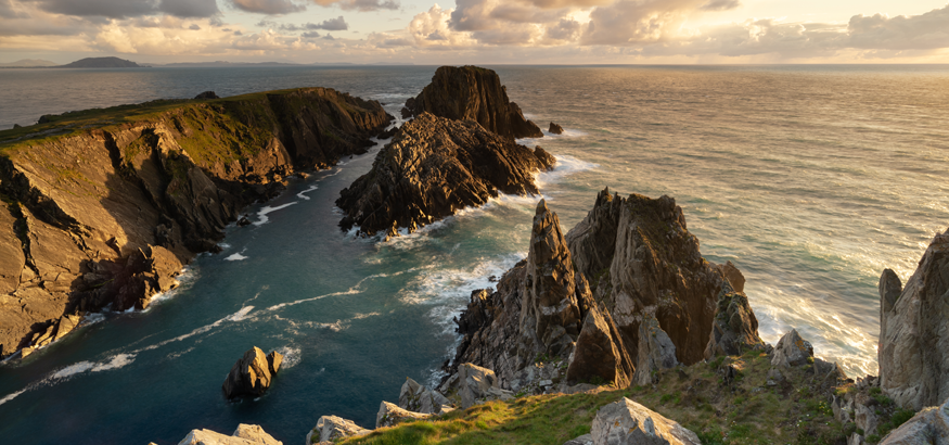 A scenic view of the Irish Sea against the sky during sunset.