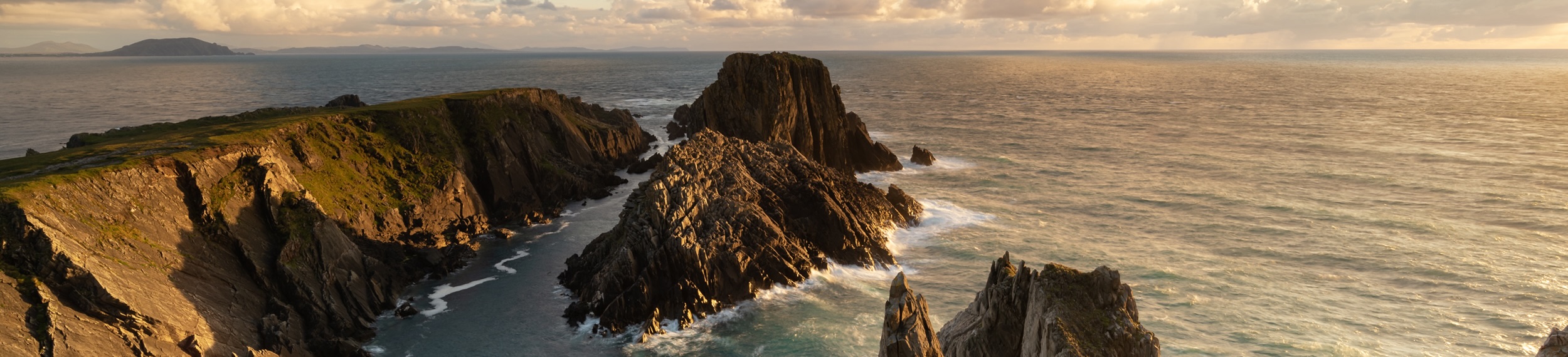 A scenic view of the Irish Sea against the sky during sunset. 