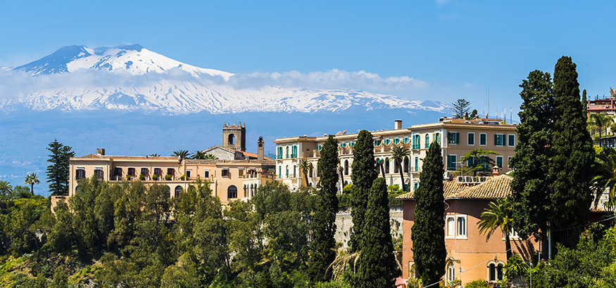 Mt. Etna serves as a backdrop to a hotel in Taormina, Sicily.