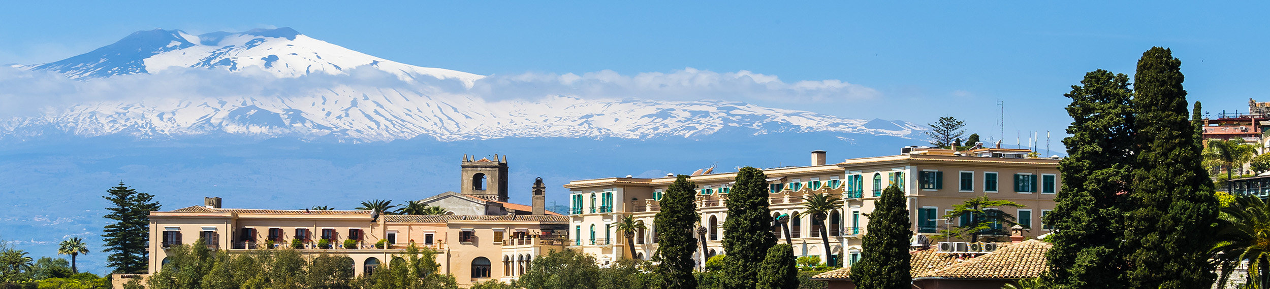 Mt. Etna serves as a backdrop to a hotel in Taormina, Sicily.
