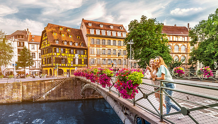 Two friends standing on a bridge in Strasbourg. 