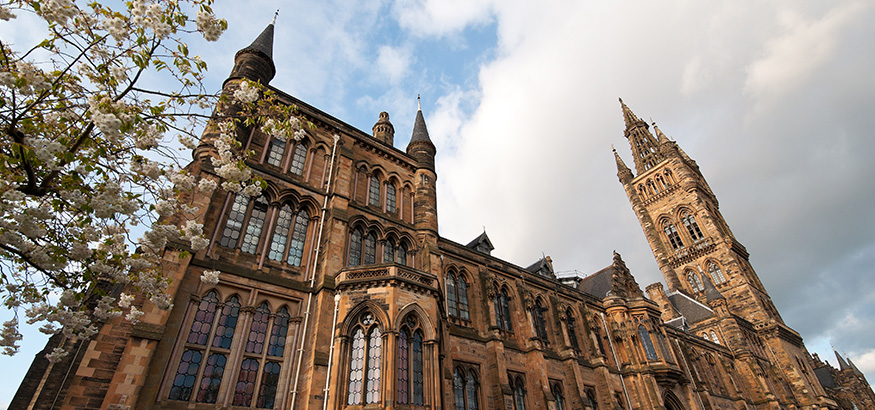 Looking up at the exterior of the main building of the University of Glasgow, Scotland.