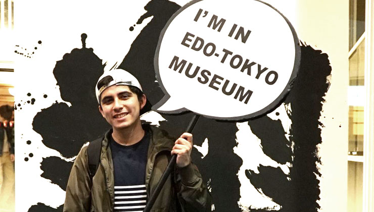 UC Santa Cruz student holds a sign that says “I’m in Edo-Tokyo Museum" in Tokyo, Japan.