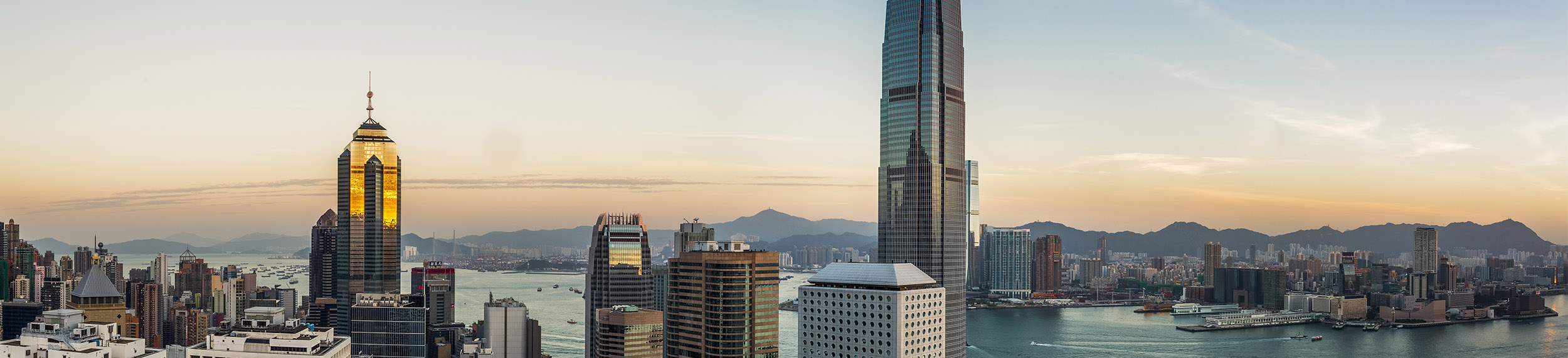 A view of the Hong Kong University of Science and Technology with buildings and water in the distance.