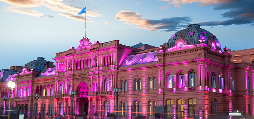 The federal building of Casa Rosada lit with pink lights at dusk in Buenos Aires, Argentina. 