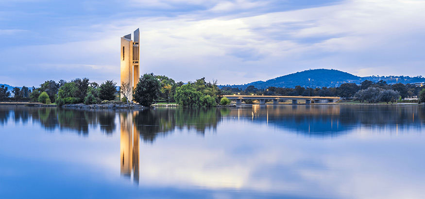 View of the National Carillion reflected in Lake Bruley Griffin at dawn in Canberra, Australia. 
