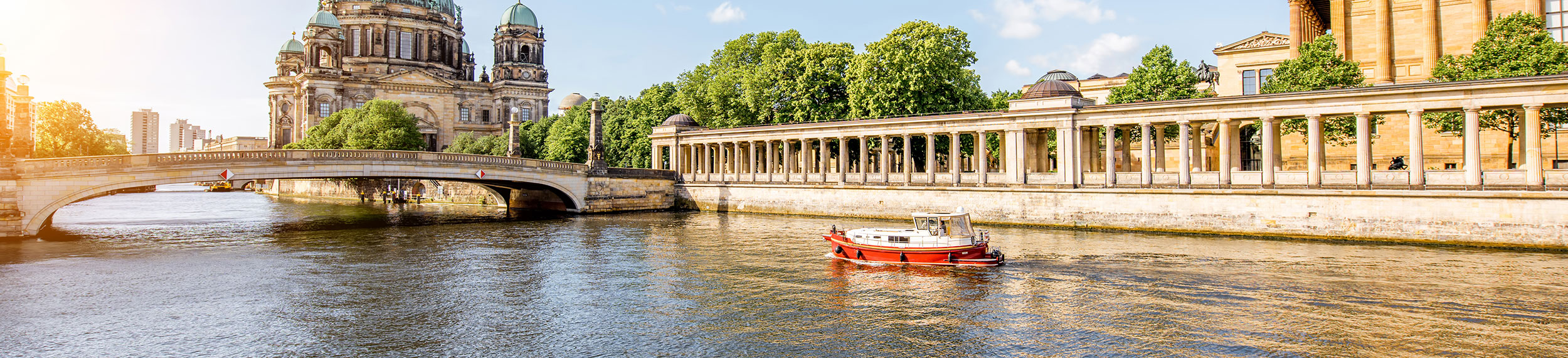 Tourist ship passing Museum Island and Berlin Cathedral on River Spree in Berlin, Germany. 