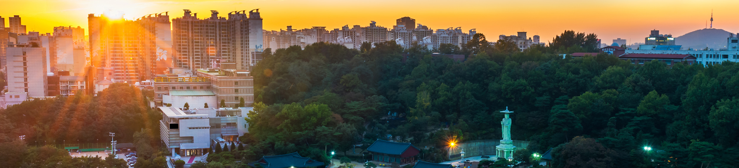 The lights turn on at Bongeunsa Temple as the sun sets over Seoul, South Korea.
