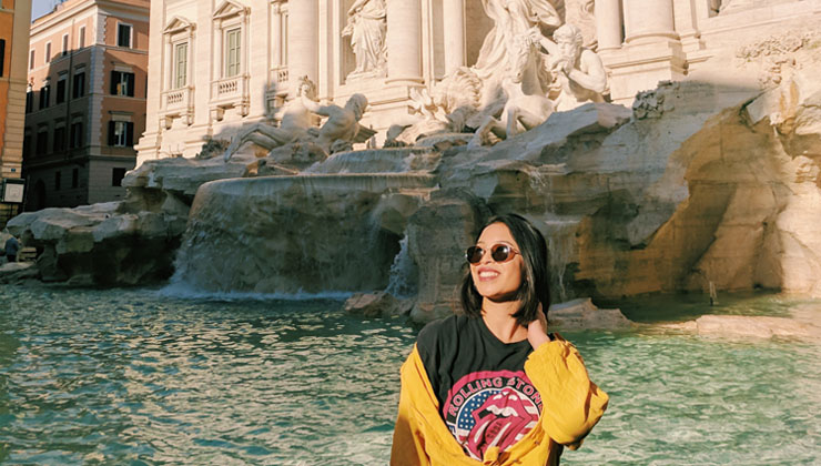 A student poses in front of the Trevi Fountain.