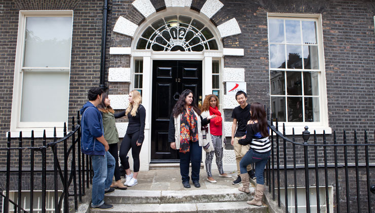 Study abroad students including UCEAP students standing outside the ACCENT London study center. 