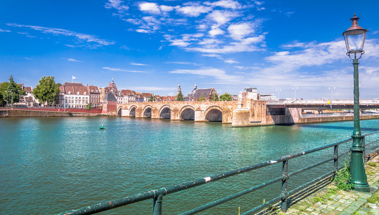 Landscape shot of the Servatius bridge across the Meuse River in Maastricht, Netherlands. 