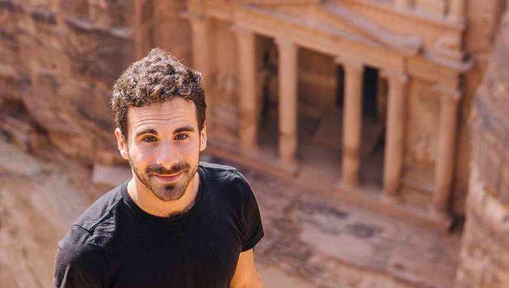 Student smiling up at camera at the ancient ruins of Petra, Jordan