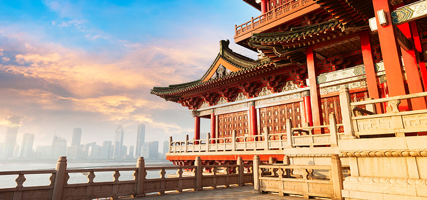 Ancient Chinese architecture with city skyline in background