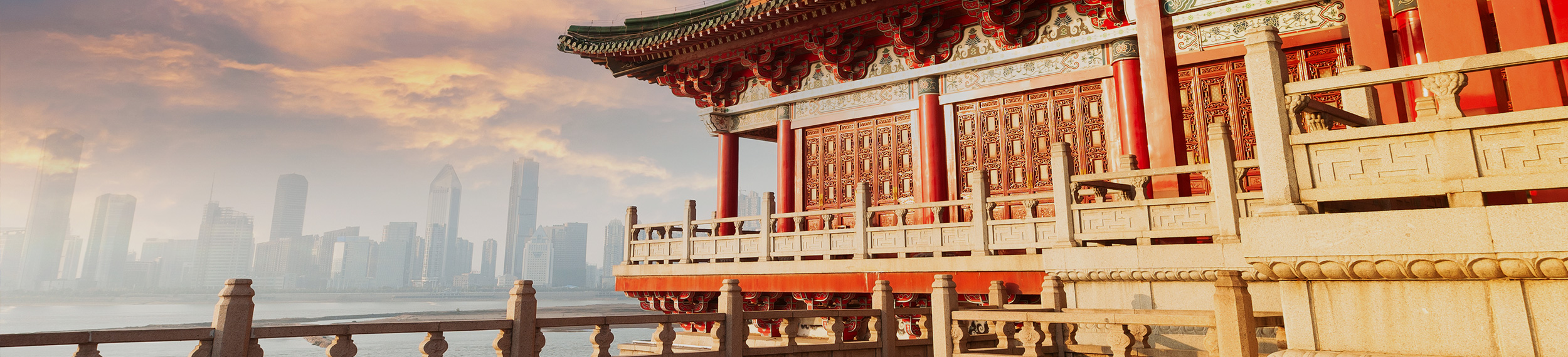 Ancient Chinese architecture with city skyline in background