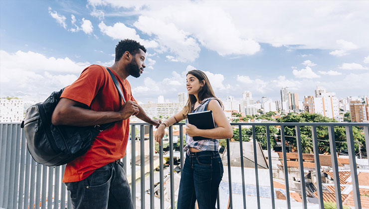 Two Brazilian students chatting on a beautiful day.