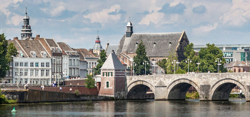 The St. Servatius Bridge and buildings near the river Meuse in Maastricht, Netherlands.
