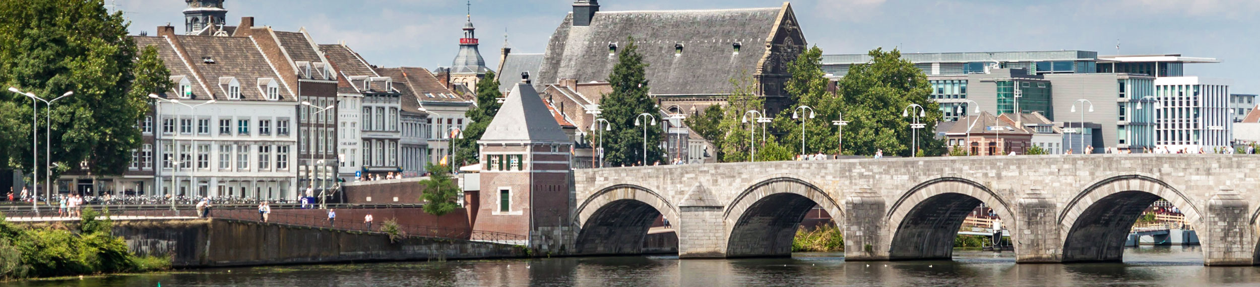 The St. Servatius Bridge and buildings near the river Meuse in Maastricht, Netherlands. 