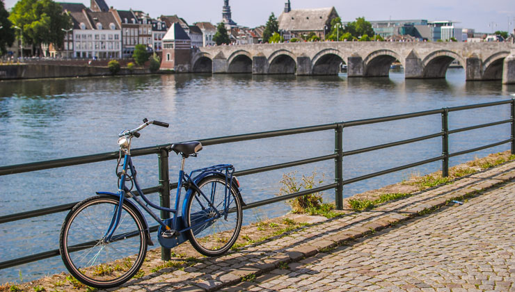 Retro style bike near the Meuse River and Saint Servatius Bridge in Maastricht, Netherlands.