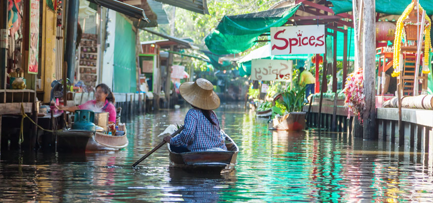 A vendor at a floating marketing in Thailand.