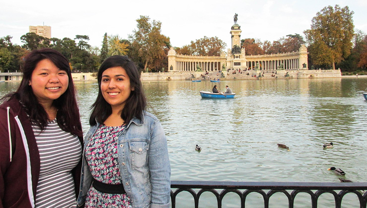 Two students smiling near El Retiro Park in Madrid, Spain. 