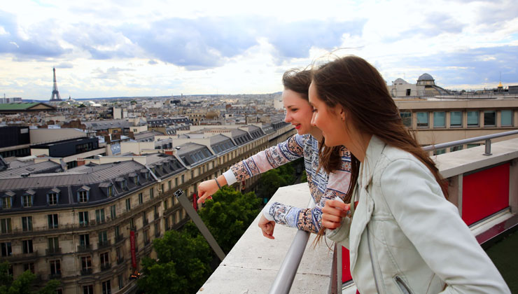 Students looking out city streets with the Eiffel Tower in the background, Paris, France. 