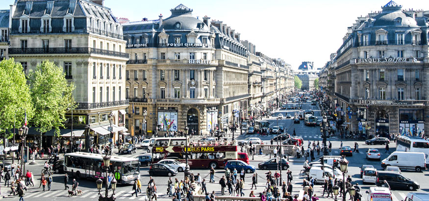 A shot of cars, buses and pedestrians in the streets of Paris, France. 