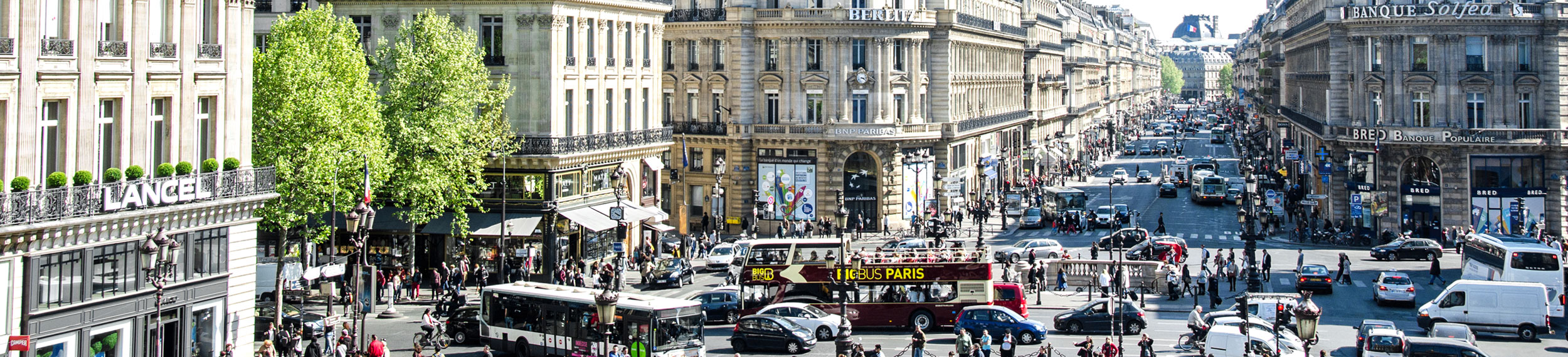 A shot of cars, buses and pedestrians in the streets of Paris, France. 
