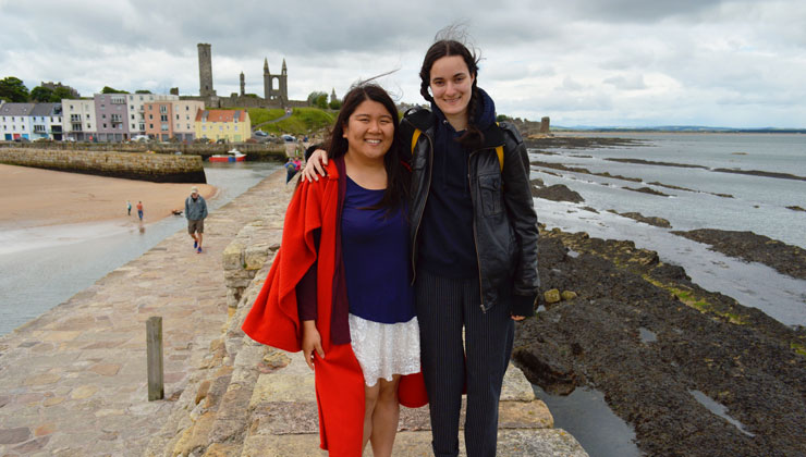 Two students posing near St. Andrews Pier in St Andrews, Scotland.