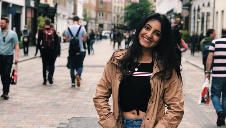 Female student looking at the camera and smiling in London, England. 