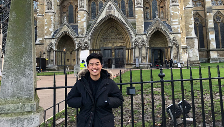 A student standing in front of Westminster Abbey in London England. 