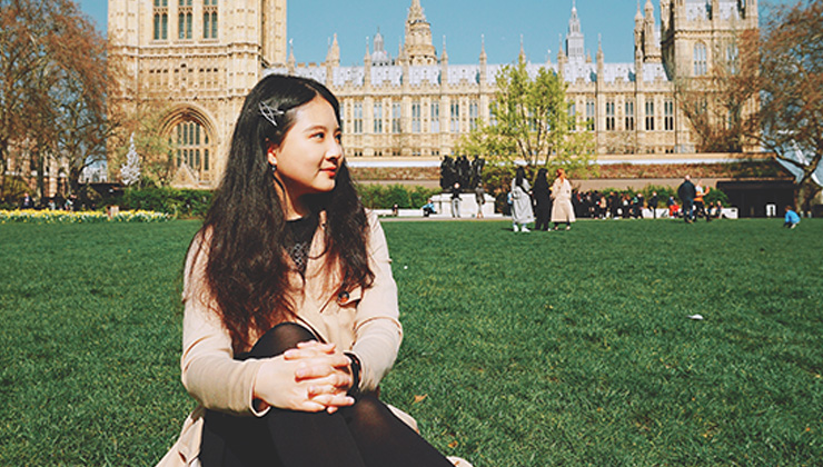 Student sitting in front of Westminster Abbey in London, England. 
