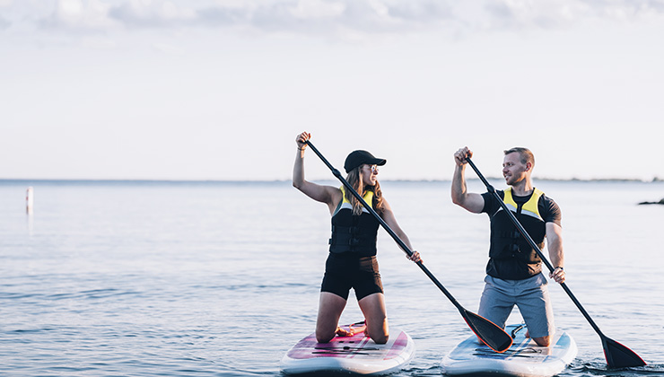 Two friends go paddle boarding on Lake Ontario.