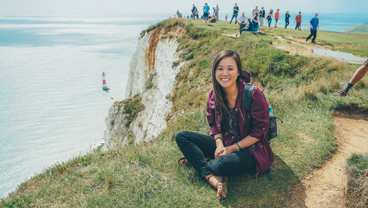 A student sitting near the Seven Sisters cliff in East Sussex, England.